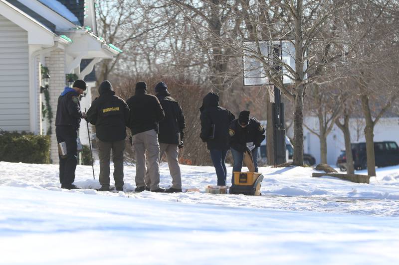 Investigators from multiple law enforcement agencies were probing the scene outside a Manchester Lane home in the River Walk of Port Barrington neighborhood on Tuesday, Jan. 11, 2022, after McHenry County sheriff's deputies shot and killed a person who allegedly opened gunfire on a woman and deputies in the early morning hours.