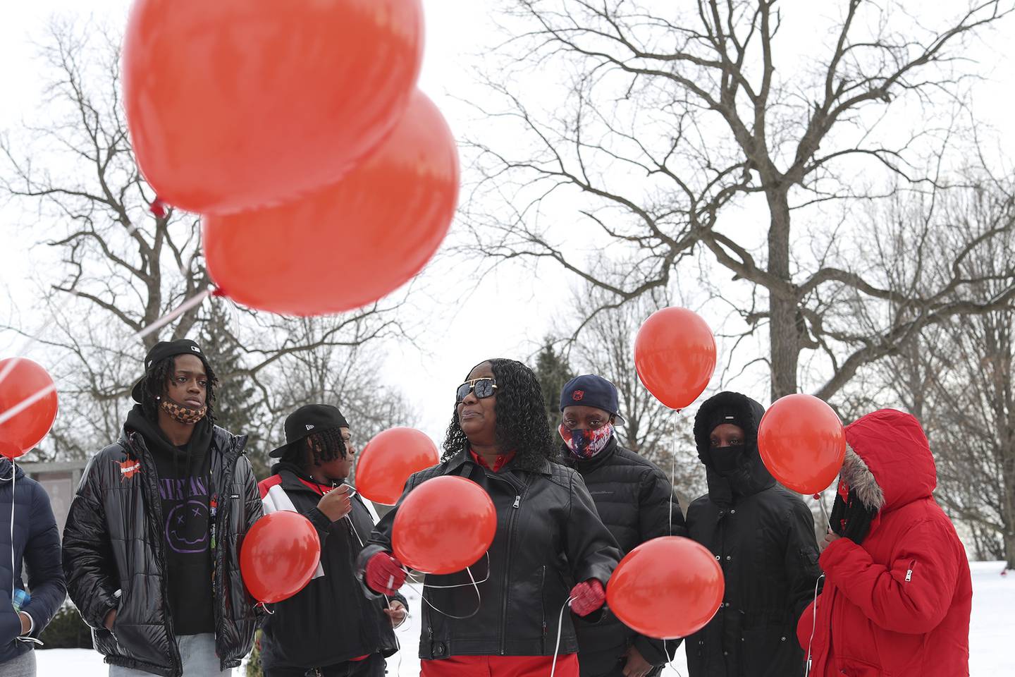 Nicole Lurry, widow of Eric Lurry, who died while in police custody last year, releases red balloons in his honor on Friday, Jan. 29, 2021, at Elmhurst Cemetery in Joliet, Ill. Friends and family held a vigil on the one year anniversary of the death of Eric Lurry.
