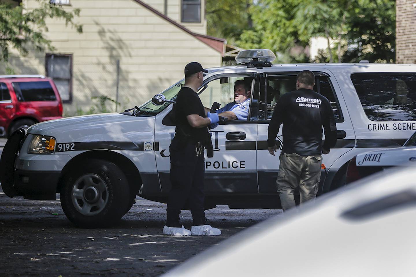 Joliet Police officers and a crime scene cleanup specialist talk outside the scene of a homicide Wednesday at the Evergreen Terrace apartment complex in Joliet A 20-year old woman was found fatally stabbed Wednesday morning in the laundry room of the complex.