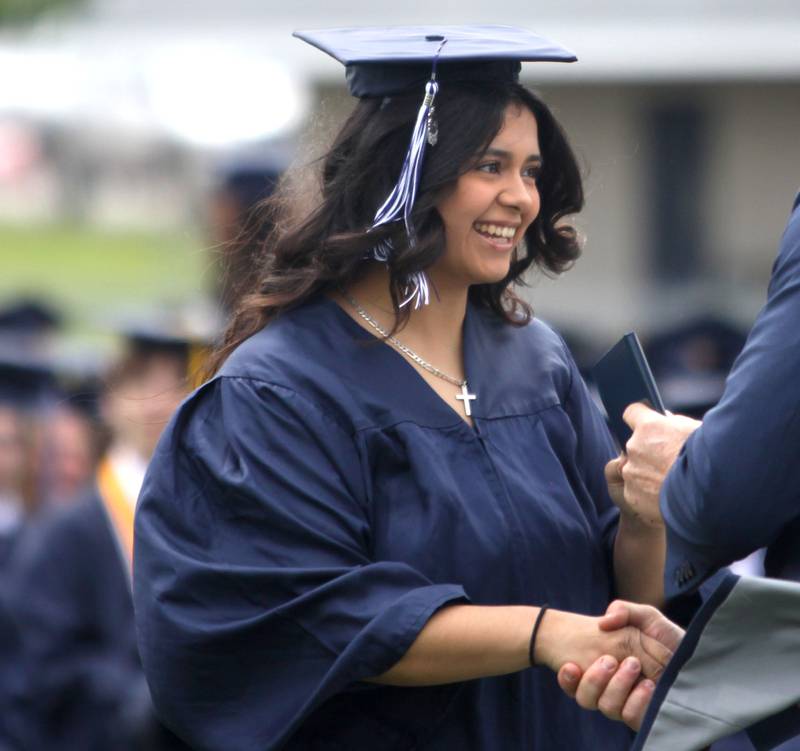 Isabella Soto receives her diploma during graduation at Cary-Grove High School in Cary on Saturday, May 17, 2025.