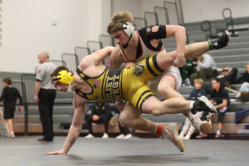 Yorkville’s Caleb Viscogliosi drops Joliet West’s Tristan Radeke in the SouthWest Prairie Conference 175 pound championship on Saturday, Jan. 24, 2026 in Minooka.