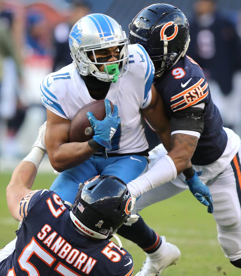 Chicago Bears linebacker Jack Sanborn and safety Jaquan Brisker bring down Detroit Lions wide receiver Kalif Raymond in the fourth quarter of their game Sunday, Nov. 13, 2022, at Soldier Field in Chicago.