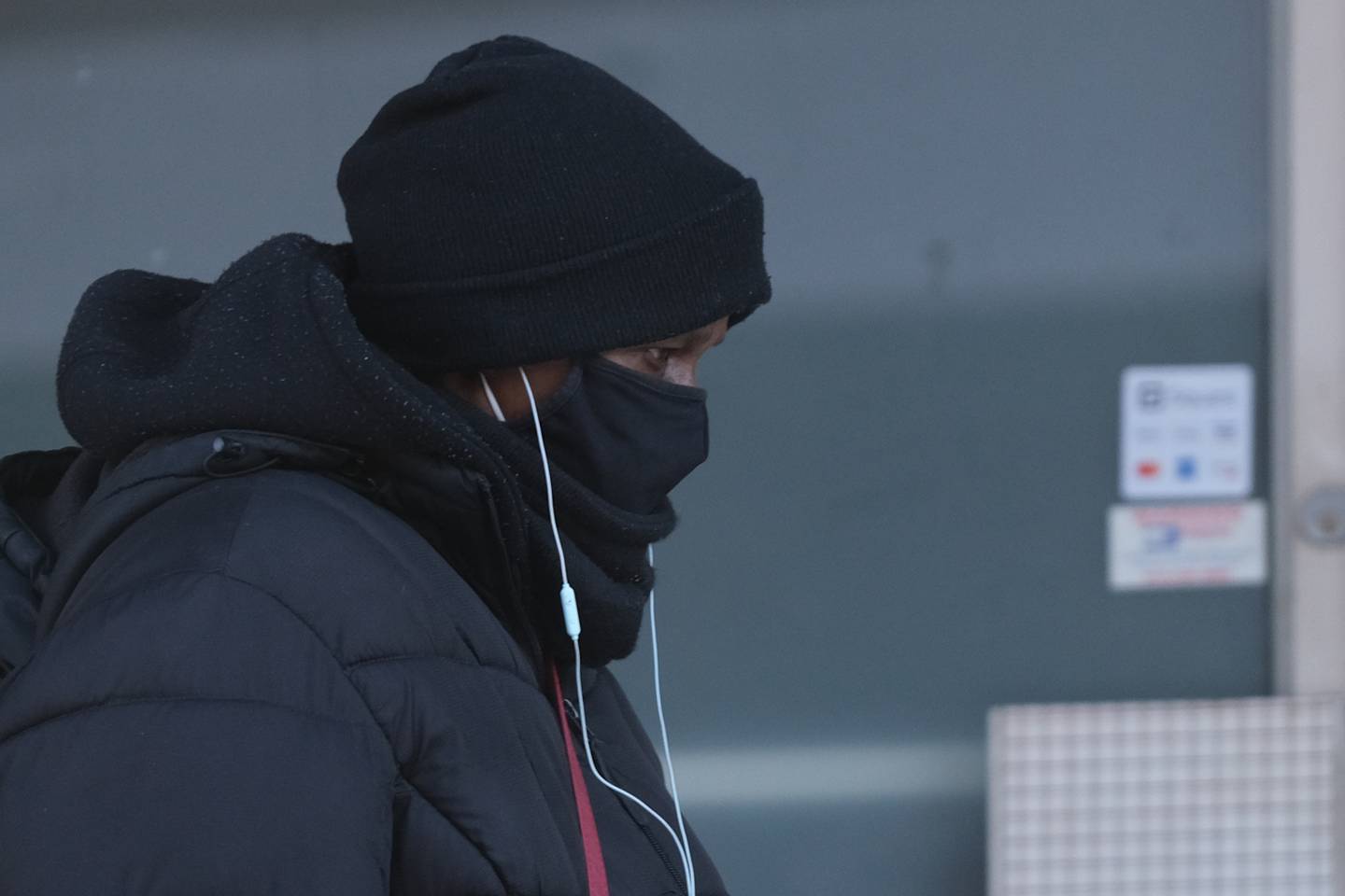 A bundled up pedestrian walks along North Chicago Street in downtown Joliet. Subzero temperatures only made it to the low teens on a bitter cold Wednesday. Wednesday, Jan. 26, 2022 in Joliet.