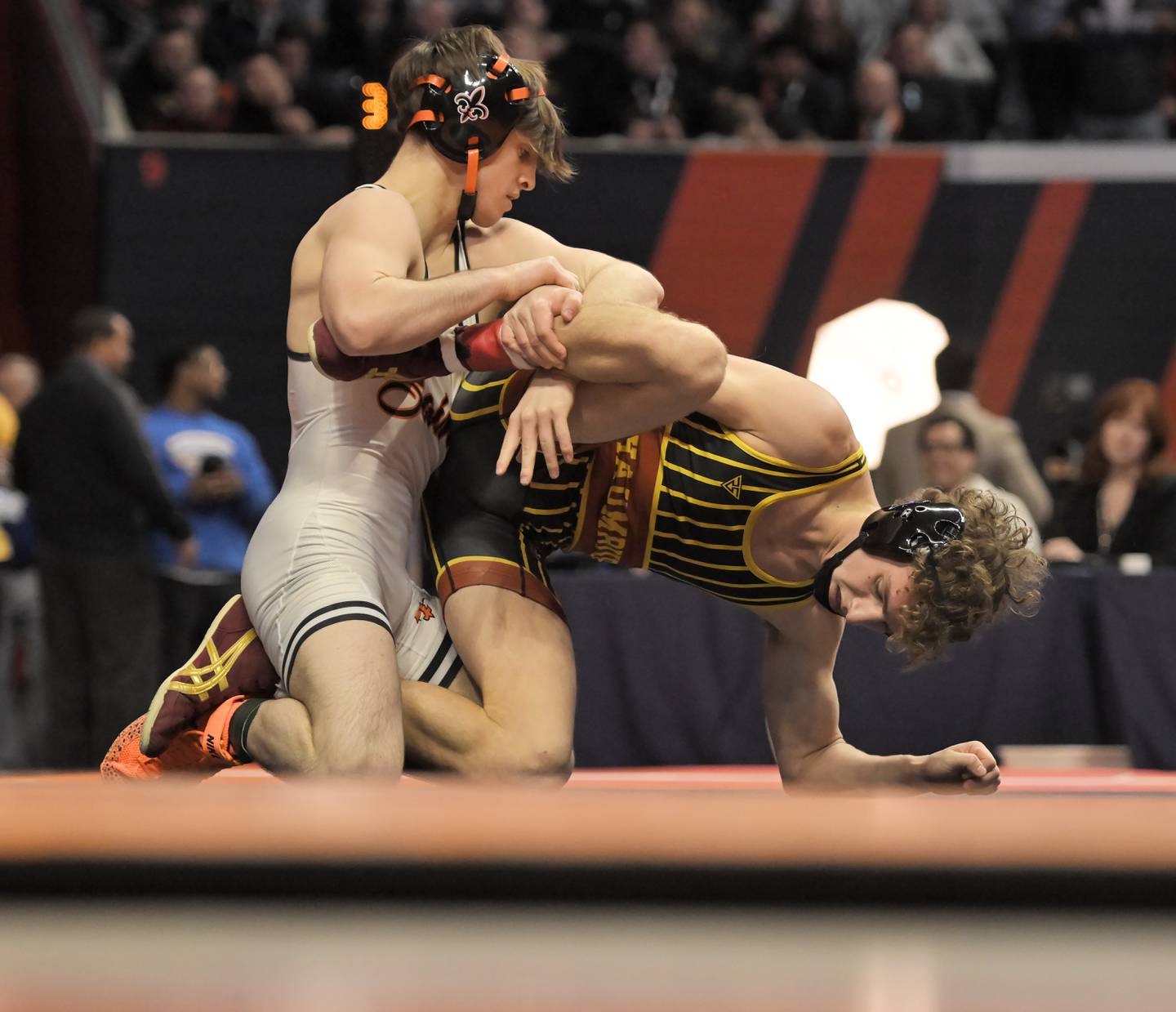 St. Charles East’s Dom Munaretto wrestles Schaumburg’s Brady Phelps in the Class 3A 120-pound final at the IHSA boys state wrestling championships at the State Farm Center in Champaign on Saturday, Feb. 22, 2025.