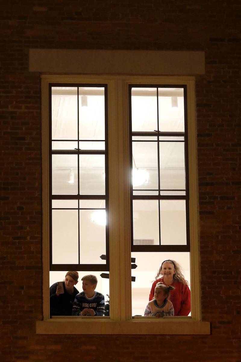 People watch as Mrs. Claus and Santa Claus arrive on the square for the Lighting of the Square Ceremony on Friday, Nov. 28, 2025, in Woodstock.The annual holiday season event featured brass music, caroling, free doughnuts and cider, food trucks, festive selfie stations and shopping.