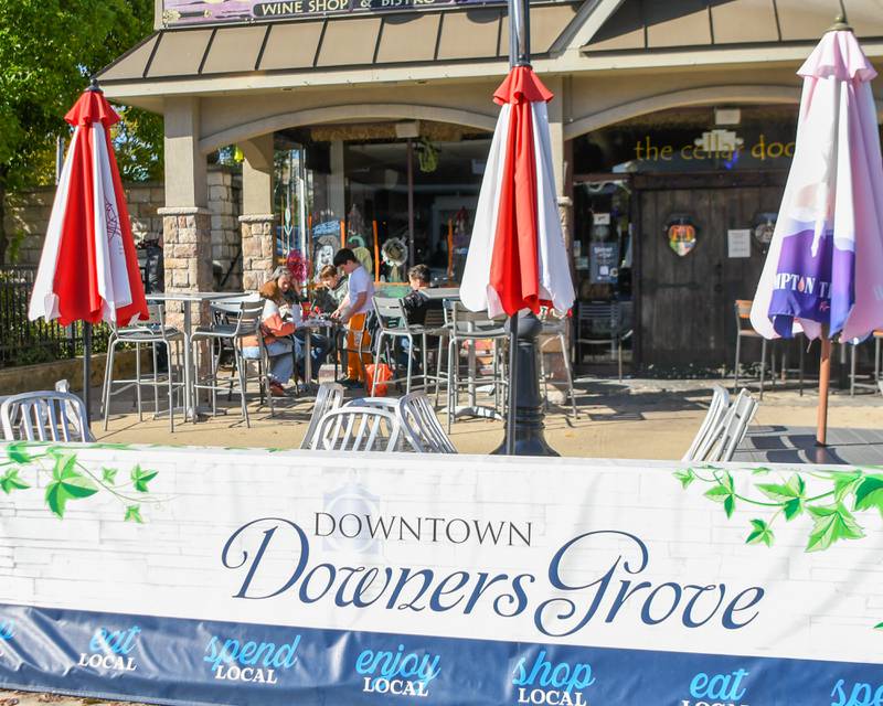 Participants paint windows during the Halloween Window painting event held downtown Downers Grove on Saturday Oct. 21, 2023.