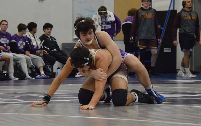 Rochelle's Josh Lassiter (purple) gets the upper hand in his match during a dual meet with Sandwich and Morris on January 8.