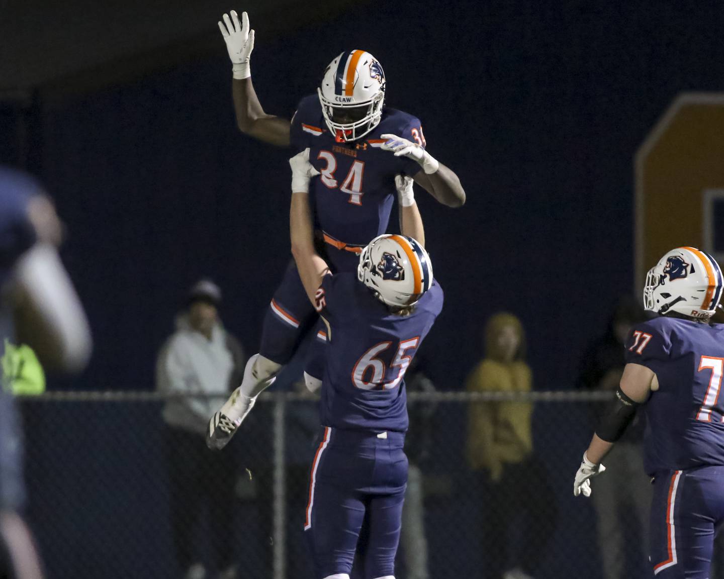 Oswego's Ammar Banire (34) celebrates his touchdown run with Nathan Overstreet (65) during Class 8A semifinal football game between Lockport at Oswego. Saturday, Nov 22, 2025 in Oswego.