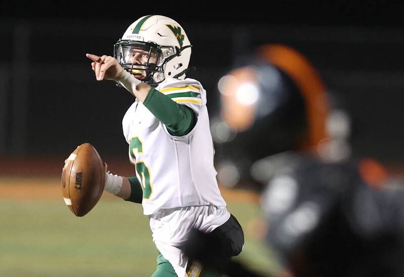 Waubonsie Valley's Luke Elsea directs traffics he looks for a receiver in the DeKalb secondary during their game Thursday, Oct. 20, 2022, at DeKalb High School.