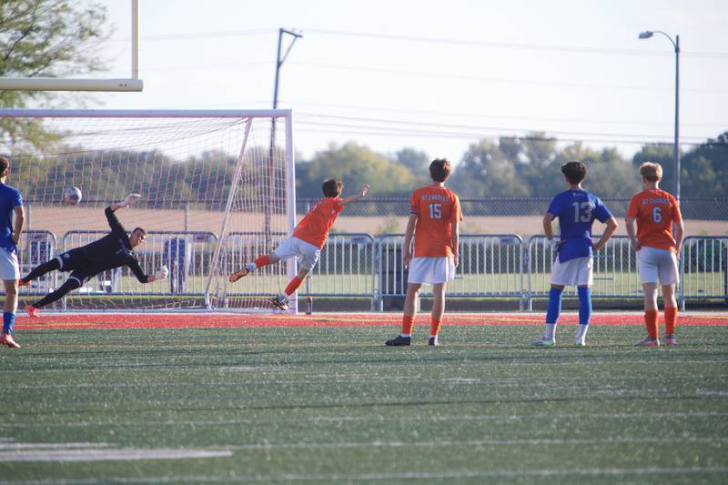 St. Charles East's Sam Arville scores a goal as the ball goes past St. Charles North's Davis Hester on Thursday, Sept. 25, 2025 in Batavia.