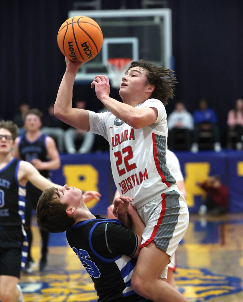 Aurora Christian's Jacob Baumann goes to the basket against Hinckley-Big Rock’s Alex Casanas during their sectional final game Friday, March 7, 2025, at Somonauk High School.