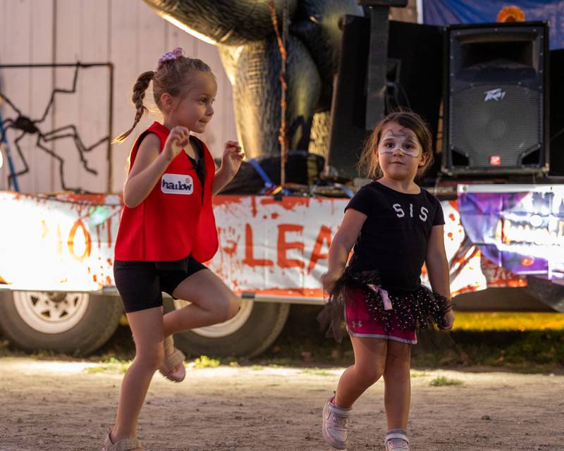 (from left) Harlo Glein does the monster mash dance with Raya Bopes at the Monster Mash Balloon Bash on Saturday, Oct. 4, 2025 at the Bureau County Fairgrounds in Princeton.