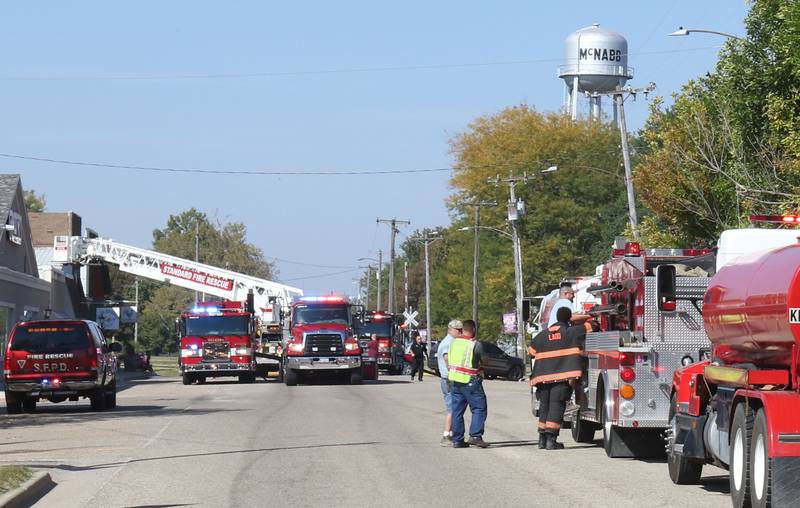 Fire trucks fill Main Street in McNabb to respond to a fire at Grassers Heating and Plumbing on Wednesday, Sept. 17, 2025 in McNabb. The fire began shortly before 10a.m. A Mutual Aid Box Alarm System (MABAS) was elevated to the fourth-alarm. No one was injured in the fire. Fire departments from McNabb, Peru, Utica, Henry, Ladd, Hennepin, Granville, Oglesby, Spring Valley, Leonore, Troy Grove, Seatonville, Wenona, Standard, Lacon-Sparland, Bureau and Tonica all responded to the scene. Firefighters left the scene at 11:30a.m.