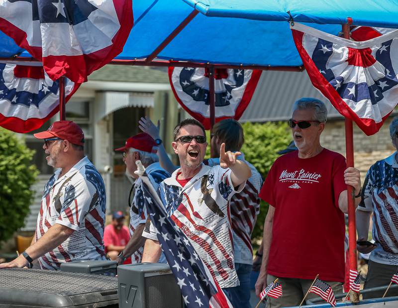 The Lamplighter Barbershop Chorus performs on their float in the annual PrairieFest parade in downtown Oswego. June 18, 2023.