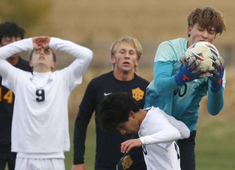 Richmond-Burton's Easton Wold grabs the ball over F.W. Parker's Rohan Liew as F.W. Parker's Johnny Backx reacts to a missed scoring opportunity during an IHSA Class 1A Johnsburg Sectional semifinal match on Oct. 28, 2025, at Johnsburg High School.