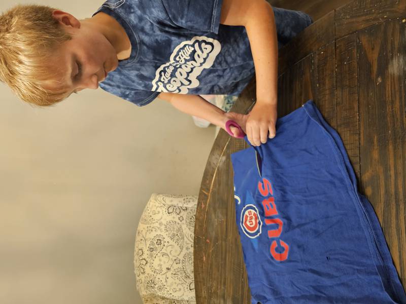 Braeden Cable of Lake in the Hills makes dog toys out of T-shirts and is one of the members of the Huntley chamber's farmers market program for kids.