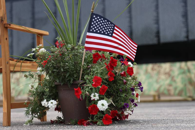 A patriotic arrangement sits next to a bench along the Vietnam Moving Wall on Saturday, July 1st, 2023, in Manhattan.