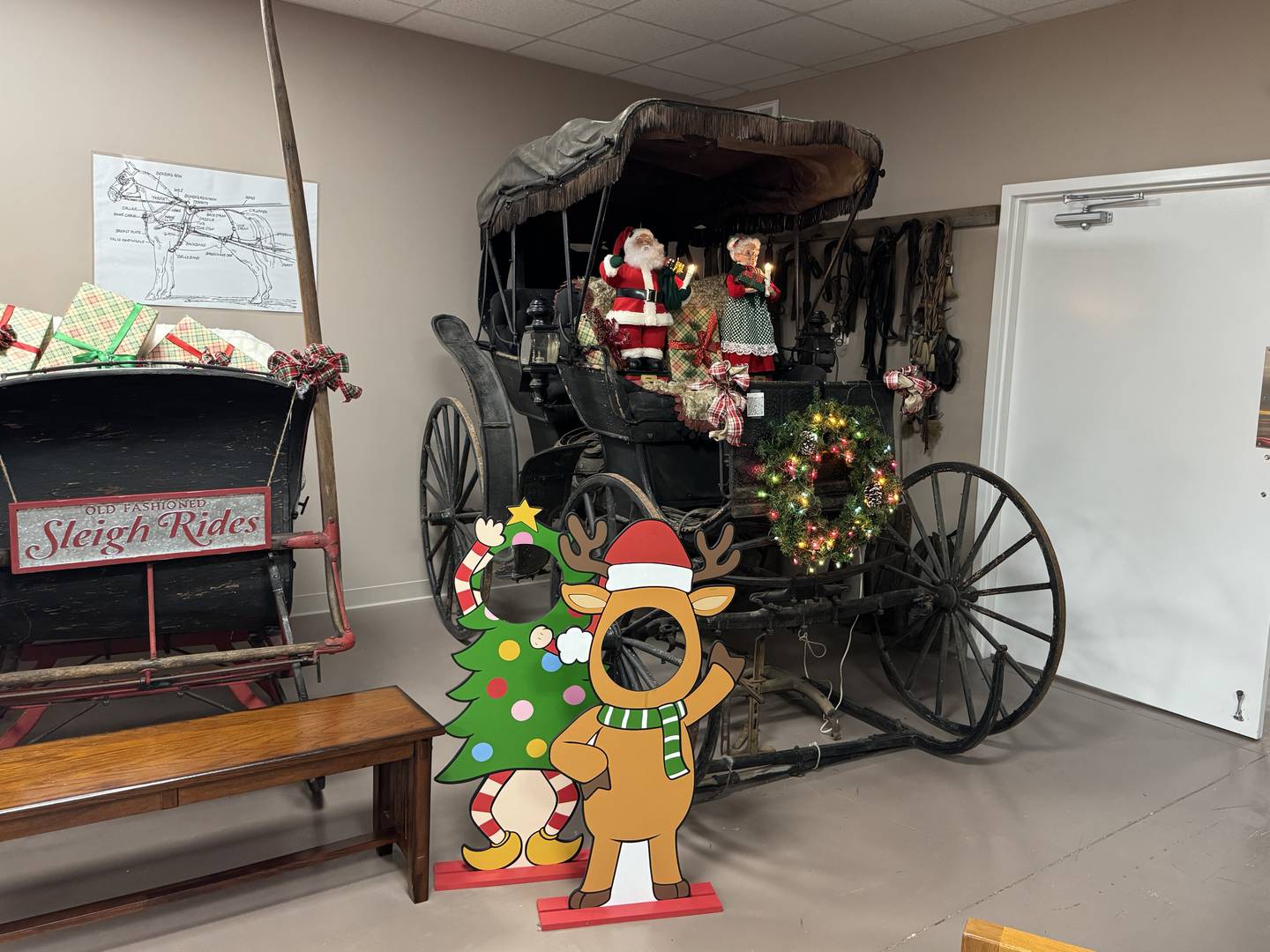 Mr. and Mrs. Claus ride inside a carriage at the Grundy County Historical Society Museum for the annual Festival of Trees.
