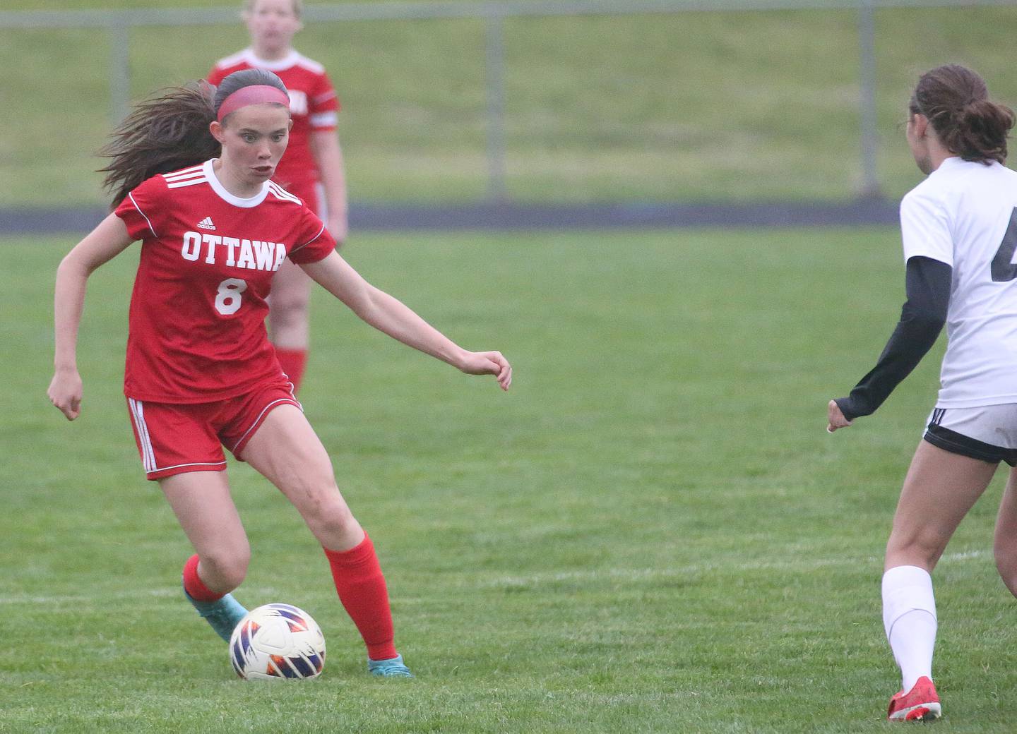 Ottawa's Georgia Kirkpatrick dribbles the ball around L-P's Amelia Buckley on Wednesday, April 30, 2025 at King Field in Ottawa.