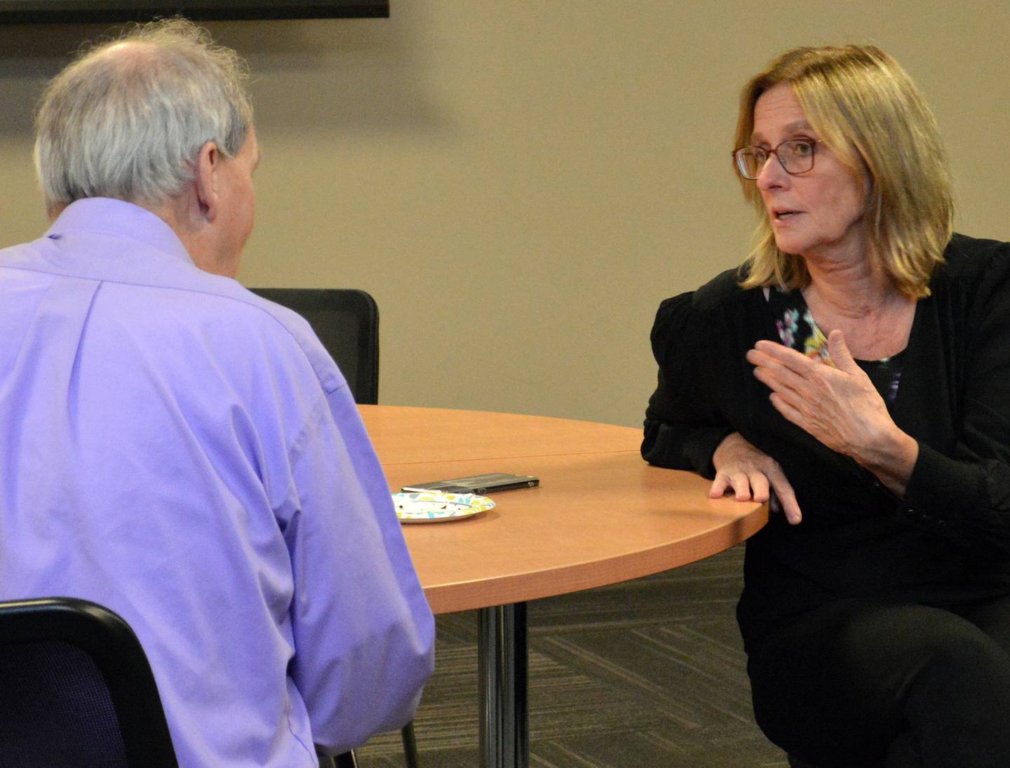 Judith de Kloe of The Netherlands (right) and IVCC science instructor Larry Ault compare college and cultural experiences during a reception for the visiting educators. The Dutch educators will return home this weekend after two weeks in the Illinois Valley.