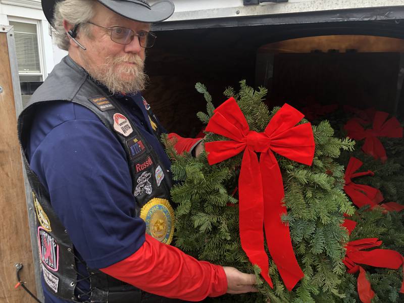 Russ Hyatt, Sons of the American Legion Post Commander, shows one of the 288 wreaths purchased by the McHenry American Legion Post 491 and laid at McHenry cemeteries on Sunday, Dec. 15, 2024.