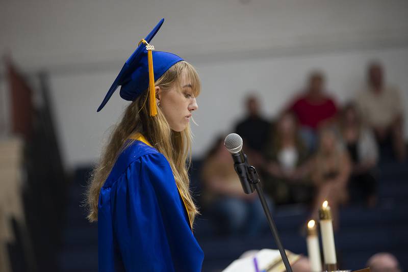 Newman salutatorian Alicia Ardis reads during baccalaureate Wednesday, May 18, 2022 before commencement of the 2022 Newman High School graduating seniors.