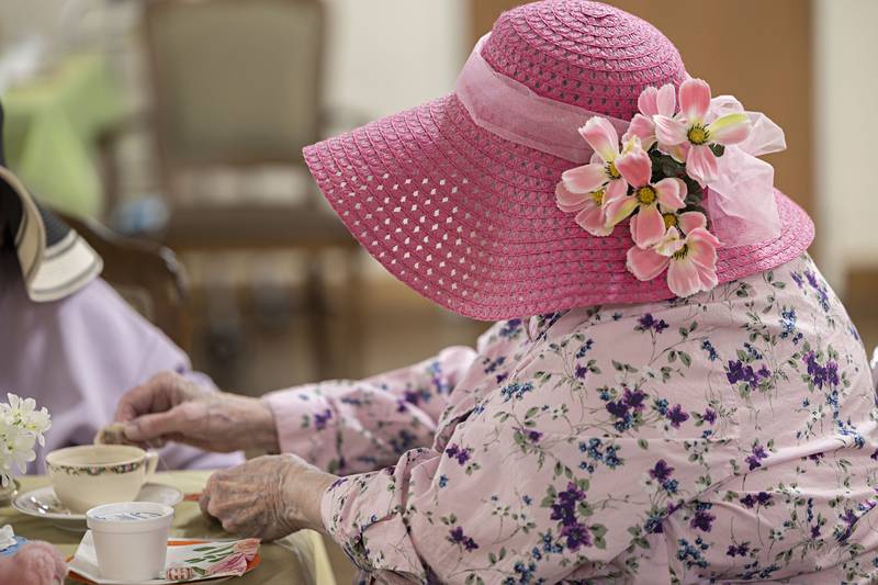 Dona Crawford wears a bright pink hat in celebration of the teddy bear tea party Friday, March 31, 2023.