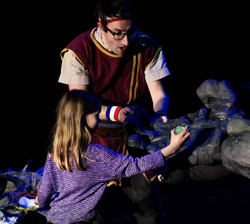 An audience member snatches a diamond from the great paw of a stone troll to help Dave the Hero Trainer on his quest during "Dragons and Mythical Beasts" which had two performances Saturday, Feb. 11, 2023, at Dixon Theatre.