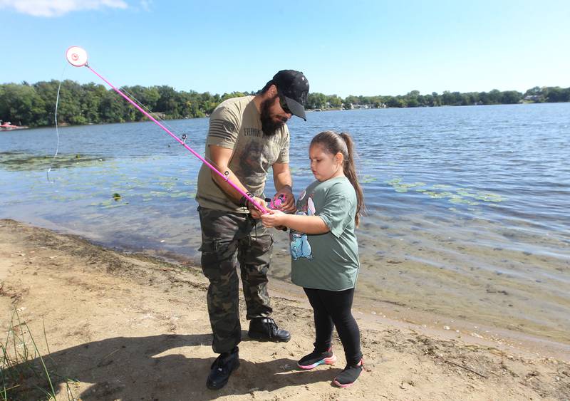 Jon Arroyo, of Round Lake Park teaches his daughter, Kayleigh, 6, how to fish during the Family Fishing Event at Lake Front Park on Saturday, September 9th in Round Lake Beach. The event was sponsored by the Round Lake Area Park District and the Huebner Fishery Management Foundation.
Photo by Candace H. Johnson for Shaw Local News Network