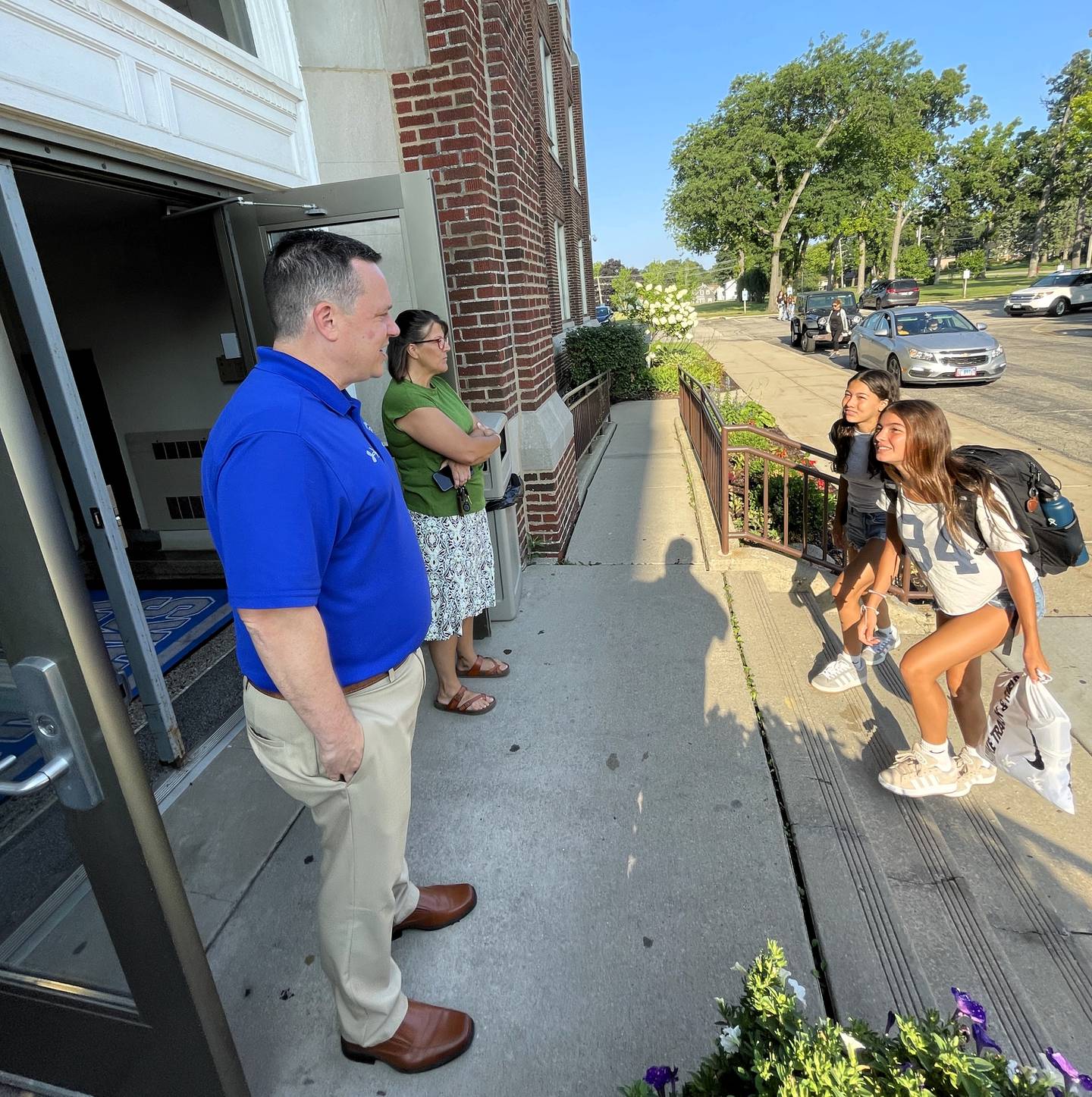 Woodstock High School Principal Art Vallicelli, left, welcomes students back on the first day of school Aug. 13, 2025.