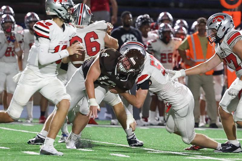 Joliet Catholic’s Zach Pomatto sheds a block to put pressure on the quarterback against Iowa City on Friday, August 30, 2024 in Joliet.