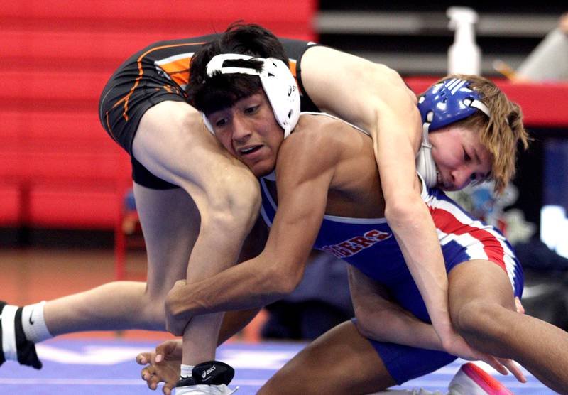 McHenry’s Myles Wagner, back, battles Dundee-Crown’s Chris Gerardo in a 126-pound bout in varsity wrestling at Carpentersville Thursday night.