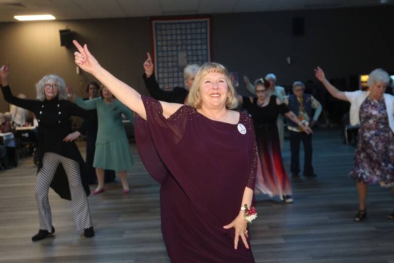 Candace Pietschmann enjoys line dancing during the Senior Prom to celebrate the 50th Anniversary of Leisure Village in Fox Lake.