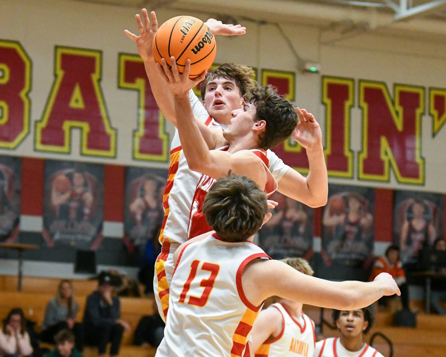 Hinsdale Central's Cole Bero, left, gets fouled by Batavia's Evan Blankenship, center, during the game on Saturday Jan. 24, 2026, held at Batavia High School.