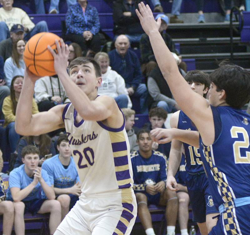 Serena’s Beau Raikes eyes the basket as Marquette’s Matthew Graham attempts a block in the 1st period Tuesday at Serena.