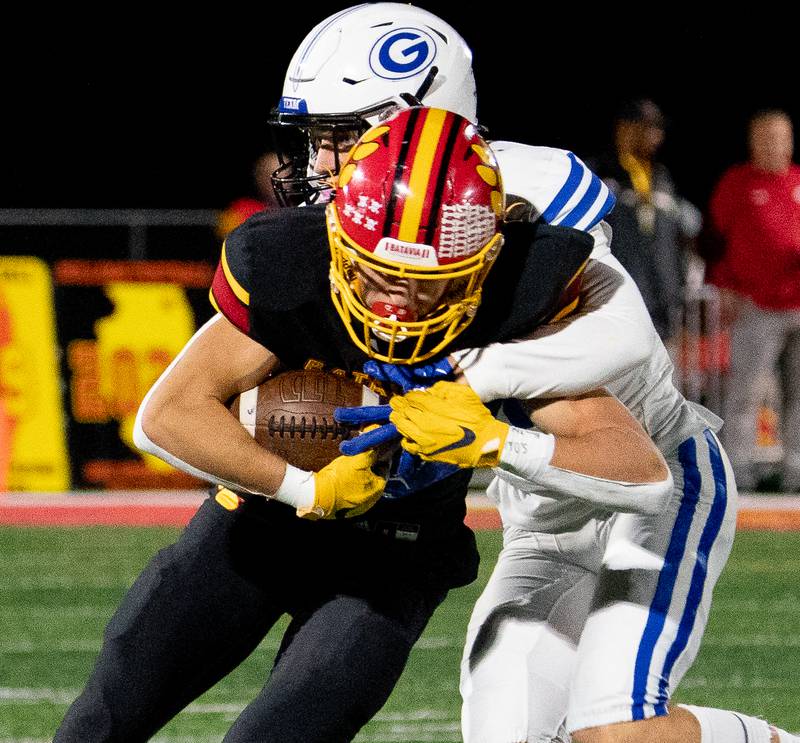 Batavia’s Gerke Drew (11) runs after the catch against Geneva’s Eli Curry (14) during a football game at Batavia High School on Friday, Oct 7, 2022.