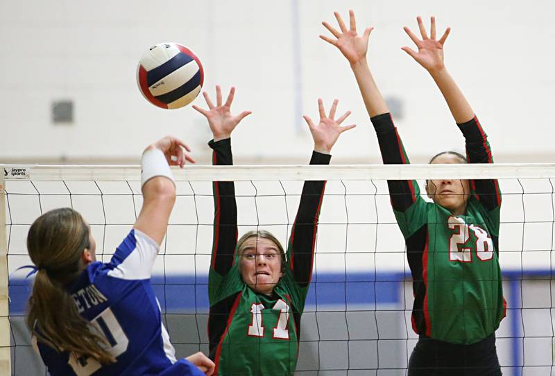 Princeton's Ellie Harp hits the ball by L-P's Mckenzie Krzyaniak and teammate Ava Currie on Tuesday, Aug. 27, 2024 at Princeton High School.