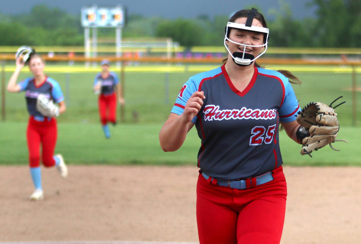 Marian Central’s Christine Chmiel is all smiles at the end of a half inning as the Hurricanes faced Winnebago to begin an IHSA Class 2A Regional game at Raymond Benoy Field in Woodstock Monday.