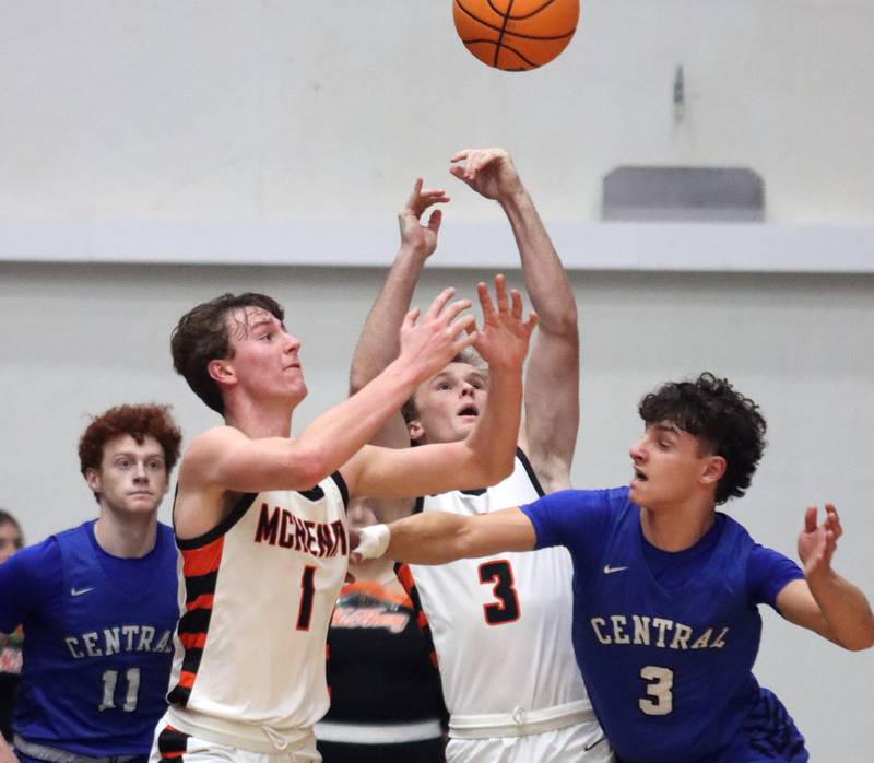 Burlington Central’s Lucas Kerr, right, races for the ball with McHenry’s Dylan Hurckes, left, and Dane Currie, center, in varsity boys basketball on Tuesday, Feb. 4, 2025, at  McHenry High School  in McHenry.