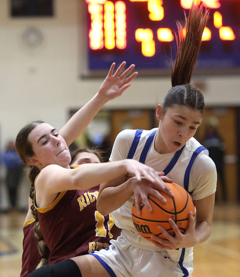 Richmond-Burton's Lilly Kwapniewski battles with Woodstock's Alex Nowacki for a rebound during a Kishwaukee River Conference girls basketball game on Wednesday, Jan. 28, 2026, at Woodstock High School.