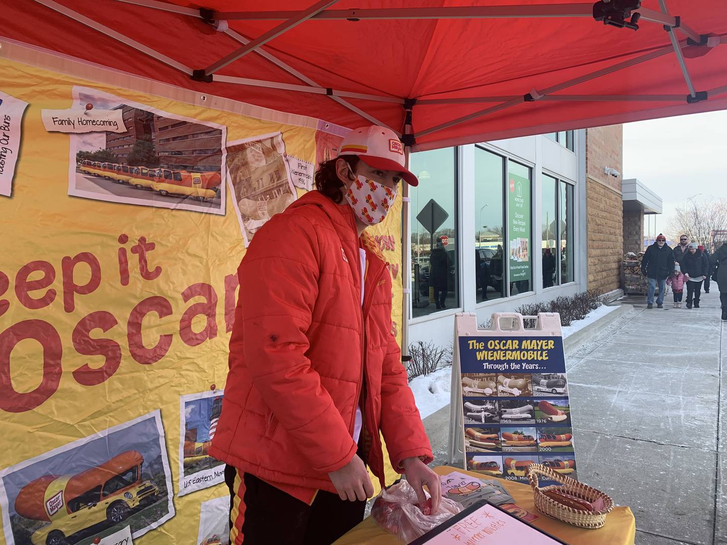 Brandon Mazzaferro of Crystal Lake and the driver of the Oscar Mayer Wienermobile visits with customers outside Mariano's in Crystal Lake on Sunday, Jan. 16, 2022.