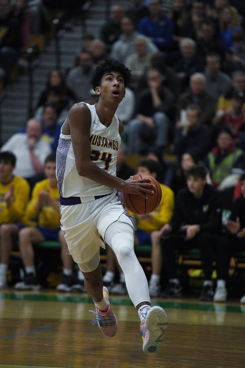 John Starks/jstarks@dailyherald.com
Rolling Meadow’s Cameron Christie drives to the basket against Lyon Township in the Jack Tosh boys basketball tournament at York High School in Elmhurst on Friday, December 30, 2022.