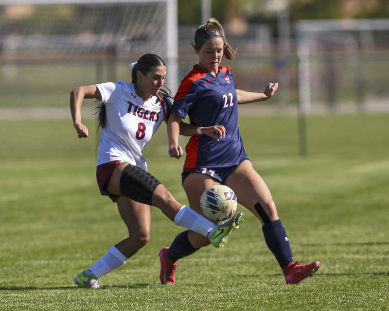 Plainfield North's Delaney Harwood (8) is defended by Oswego's Aubrey Atkins (22) during a soccer match between Plainfield North at Oswego on Monday, May 11, 2026 in Oswego.