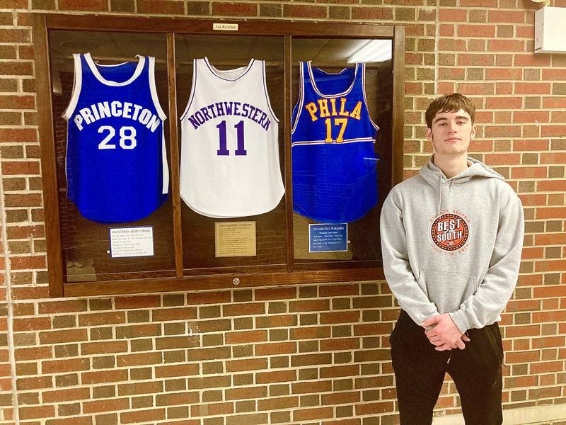 Princeton senior Grady Thompson inspects the display case at Prouty Gym honoring Tiger great Joe Ruklick, recognizing his accomplishments for PHS, Northwestern University and the NBA's Philadelphia Warriors. Thompson is just seven points from breaking Ruklick's PHS boys all-time scoring record of 1,306.