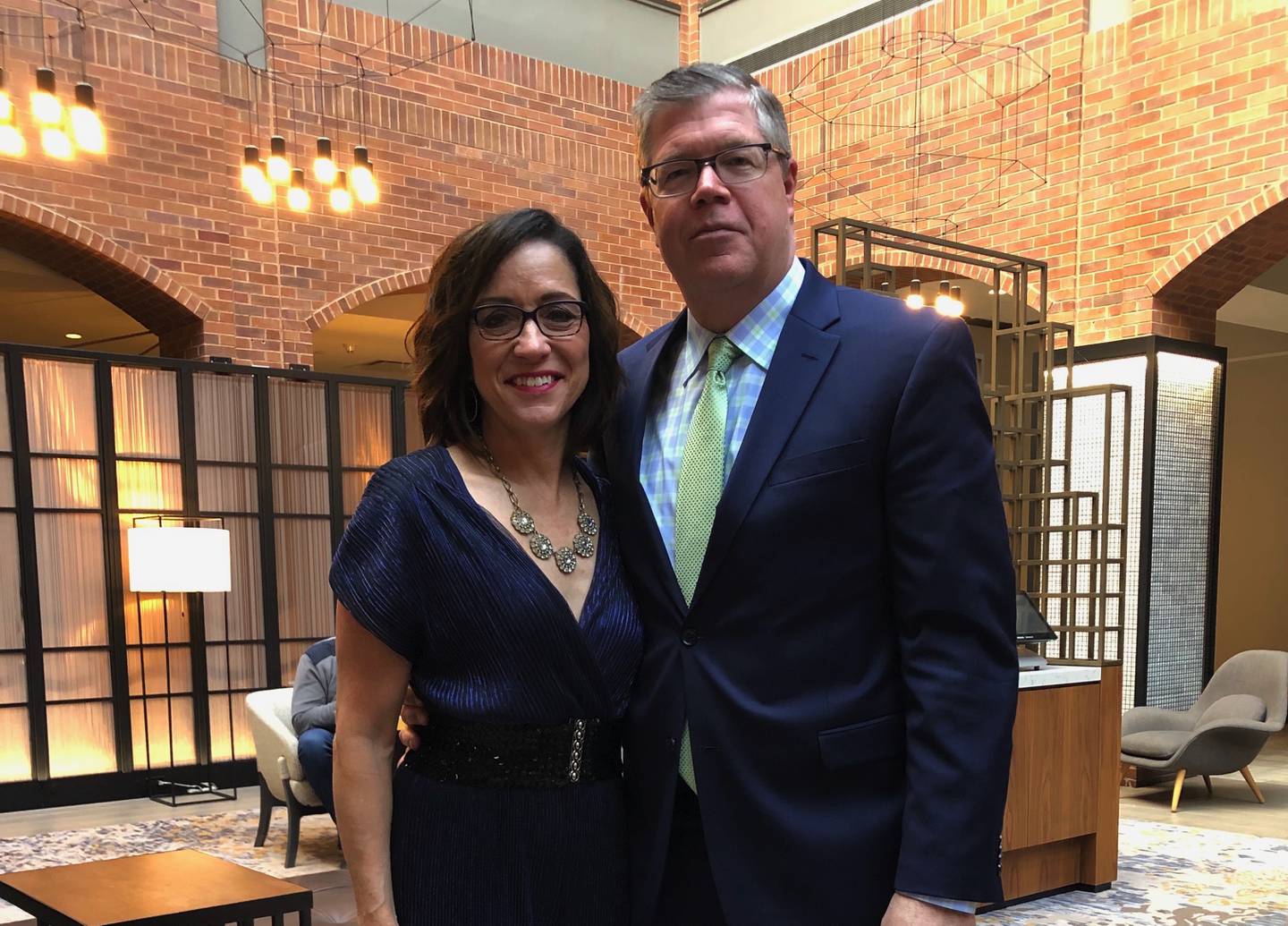 The newest member of the McHenry County Board, John Collins, stands with his wife Angel Collins at a wedding reception.