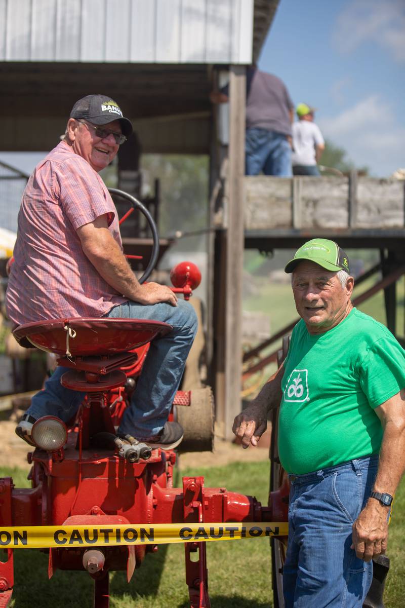 Doug Kreiser (left) and Ed Harden, both from Dixon assist with the rock crushing demonstration Saturday, August 6, 2022 at the Living History Antique Equipment Association show in Franklin Grove.