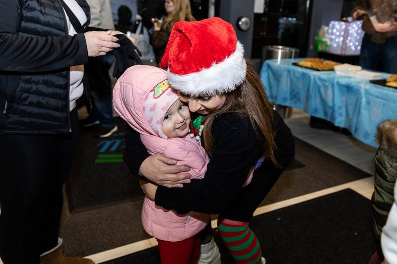 Crest Hill resident Melanie Hernandez gets a hug from Crest Hill Alderwoman Claudia Gazal during Winterfest at Crest Hill City Center on Nov. 30, 2024.