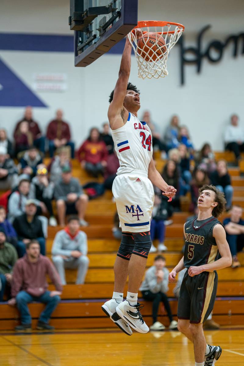 Marmion’s Trevon Roots (24) dunks the ball against Morris’ Caston Norris (5) during the 59th Annual Plano Christmas Classic basketball tournament at Plano High School on Tuesday, Dec 27, 2022.