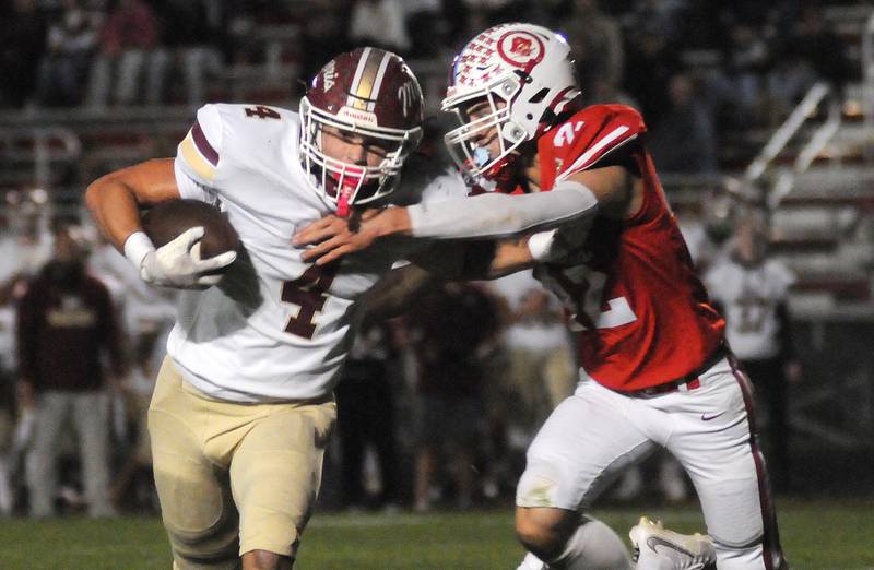Morris ball handler Mick Smith (4) tries to fight off a tackle by Ottawa's Joey Liebhart on Friday, Oct. 10, 2025 at King Field in Ottawa.