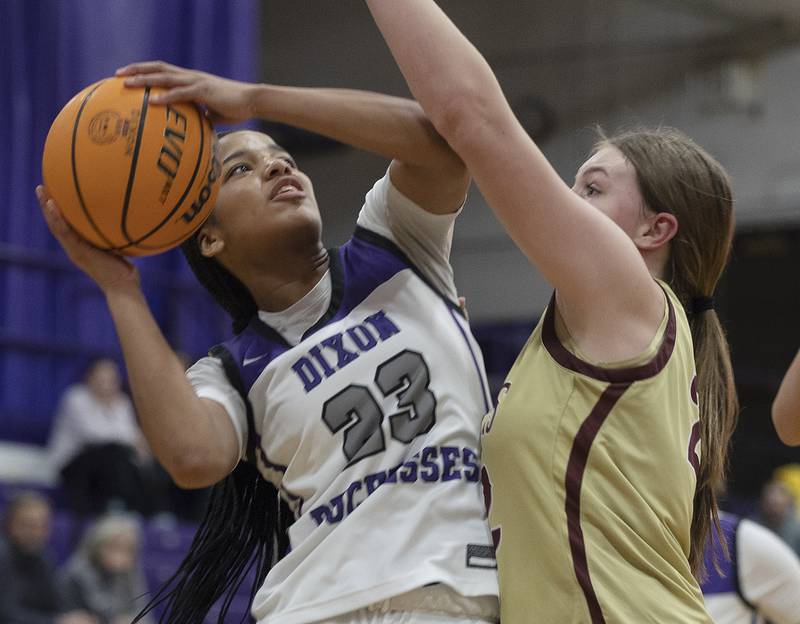 Dixon's Ahmyrie McGowan works against Morris’ Layken Callahan Friday, Jan. 3, 2025, at Dixon High School.